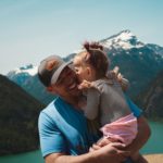man carrying her daughter smiling