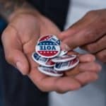 hands with vote pins