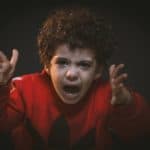 toddler with red adidas sweat shirt
