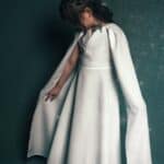 beautiful little kid in white dress with cape