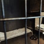 bed sink and dumbbells in cell