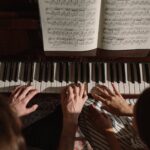 couple playing on piano