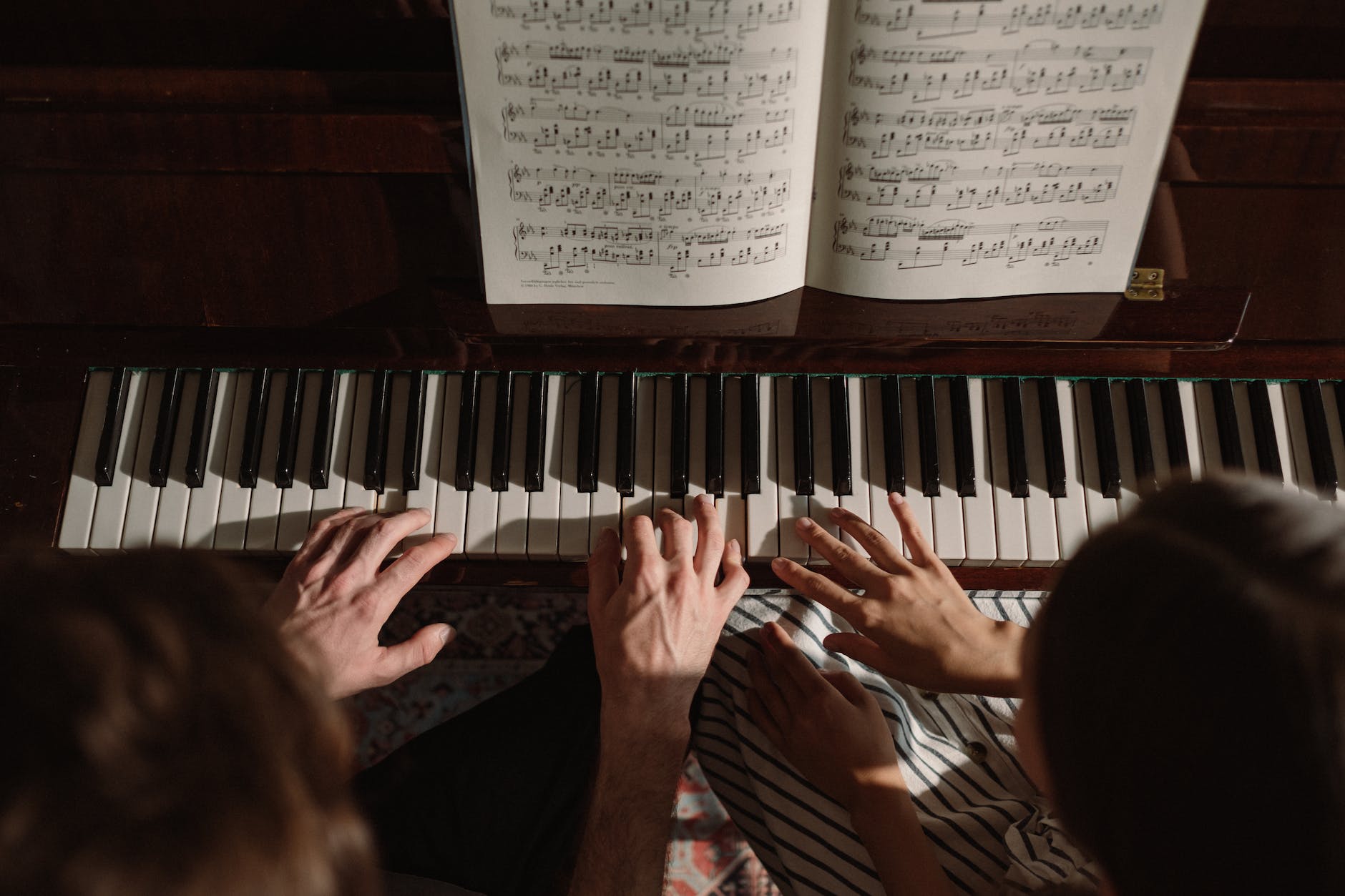 couple playing on piano